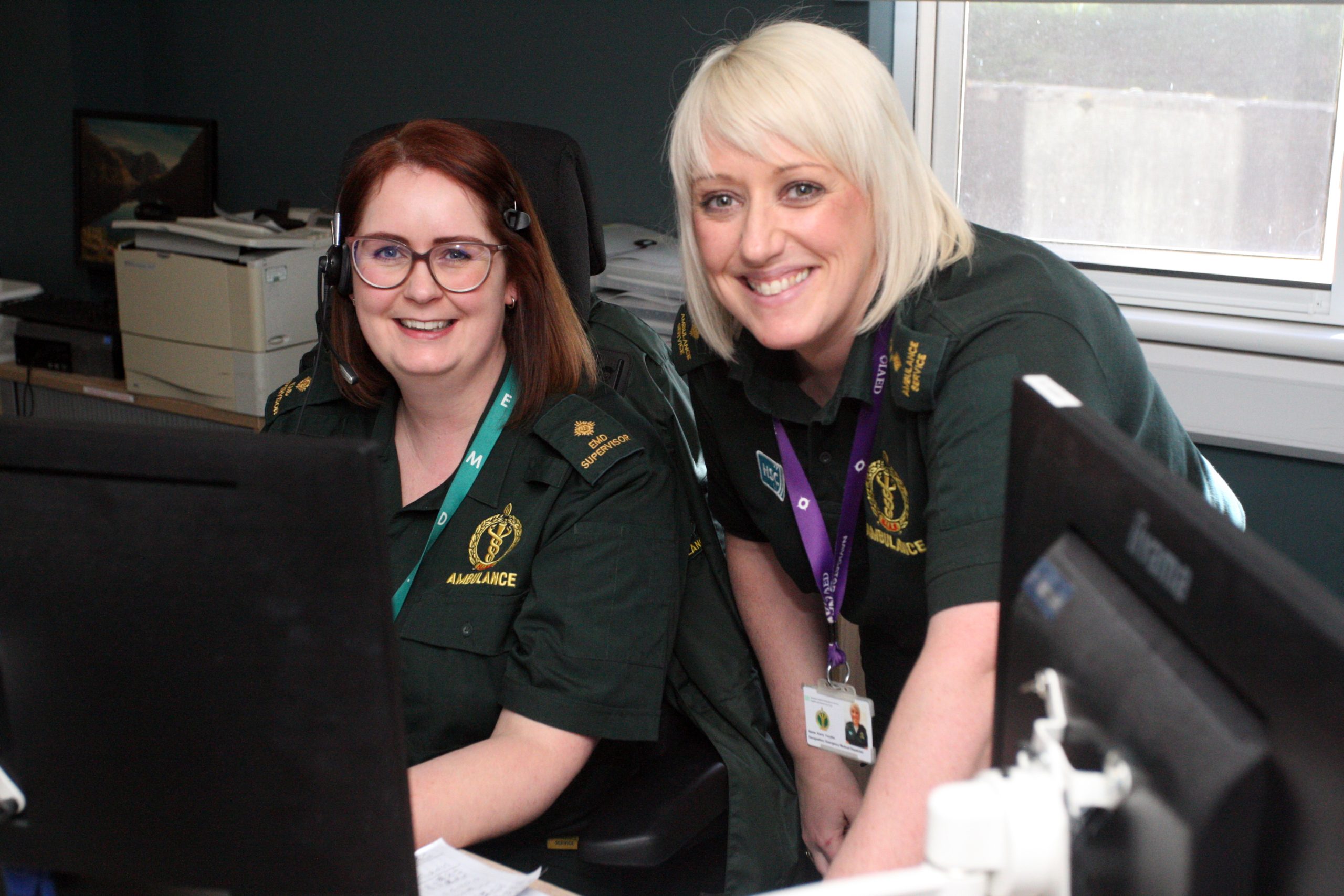 Photo of two NIAS staff members sitting at computer terminals