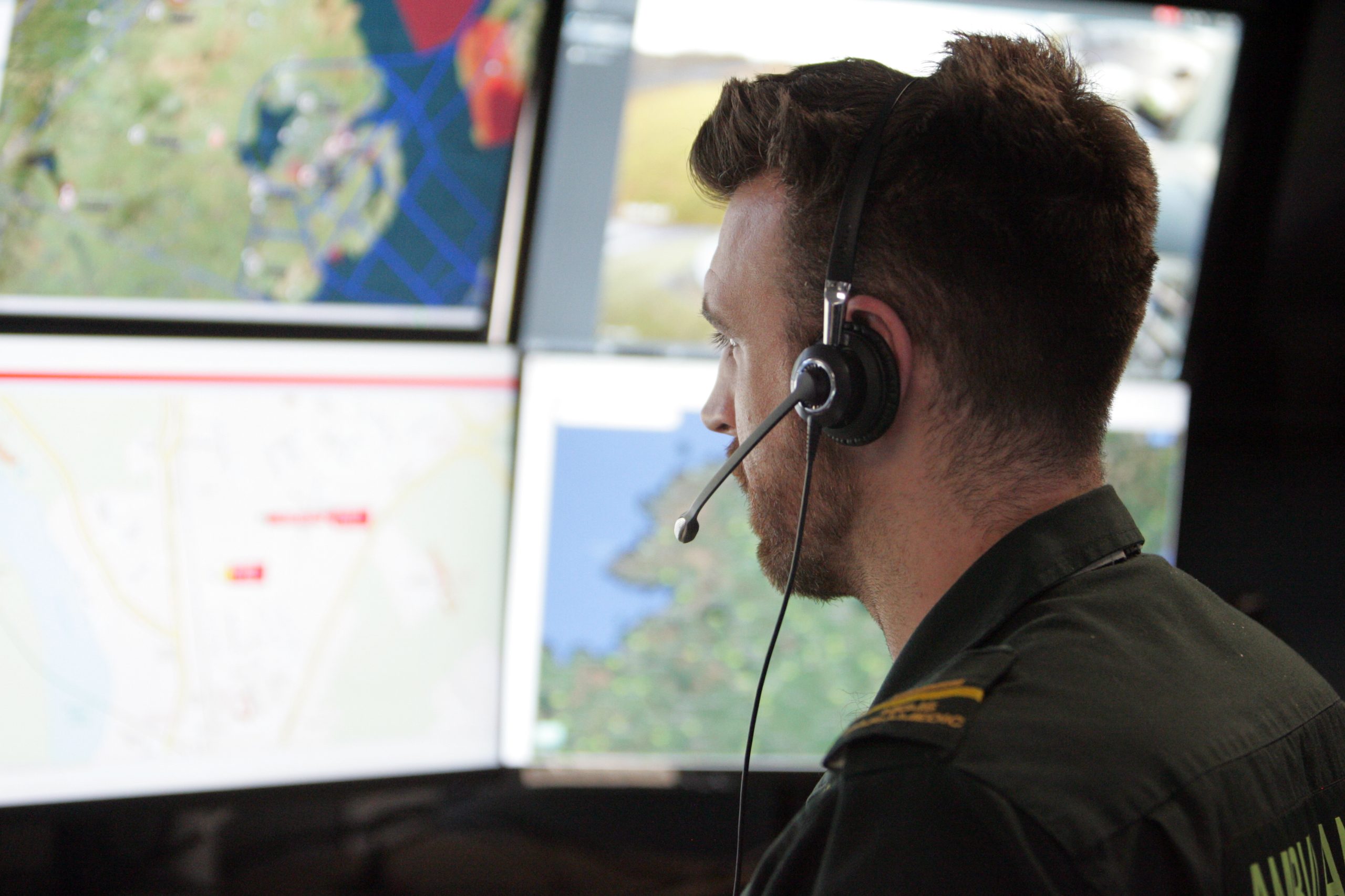 NIAS staff member looking at computer screens in an incident room