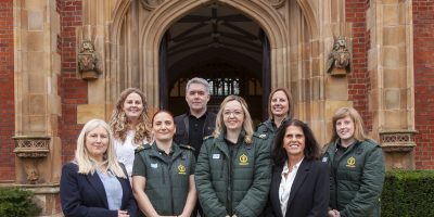 Group photo of staff outside Queens University Belfast Building