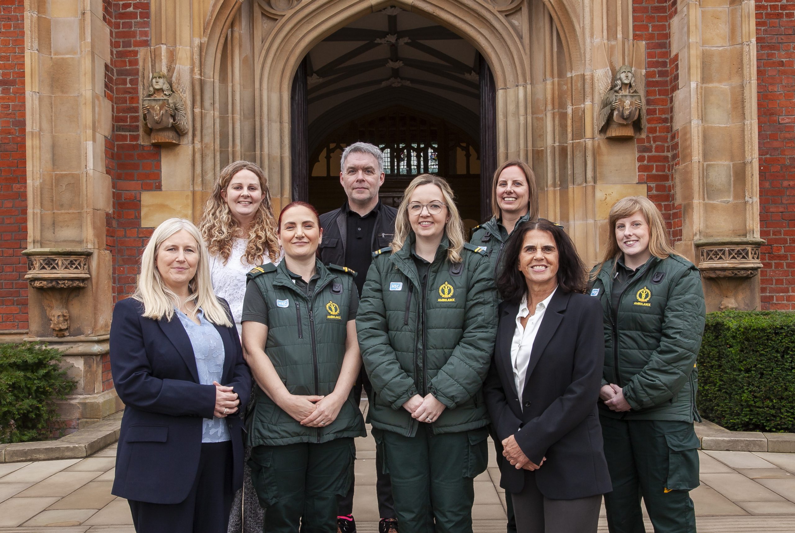 Group photo of staff outside Queens University Belfast Building