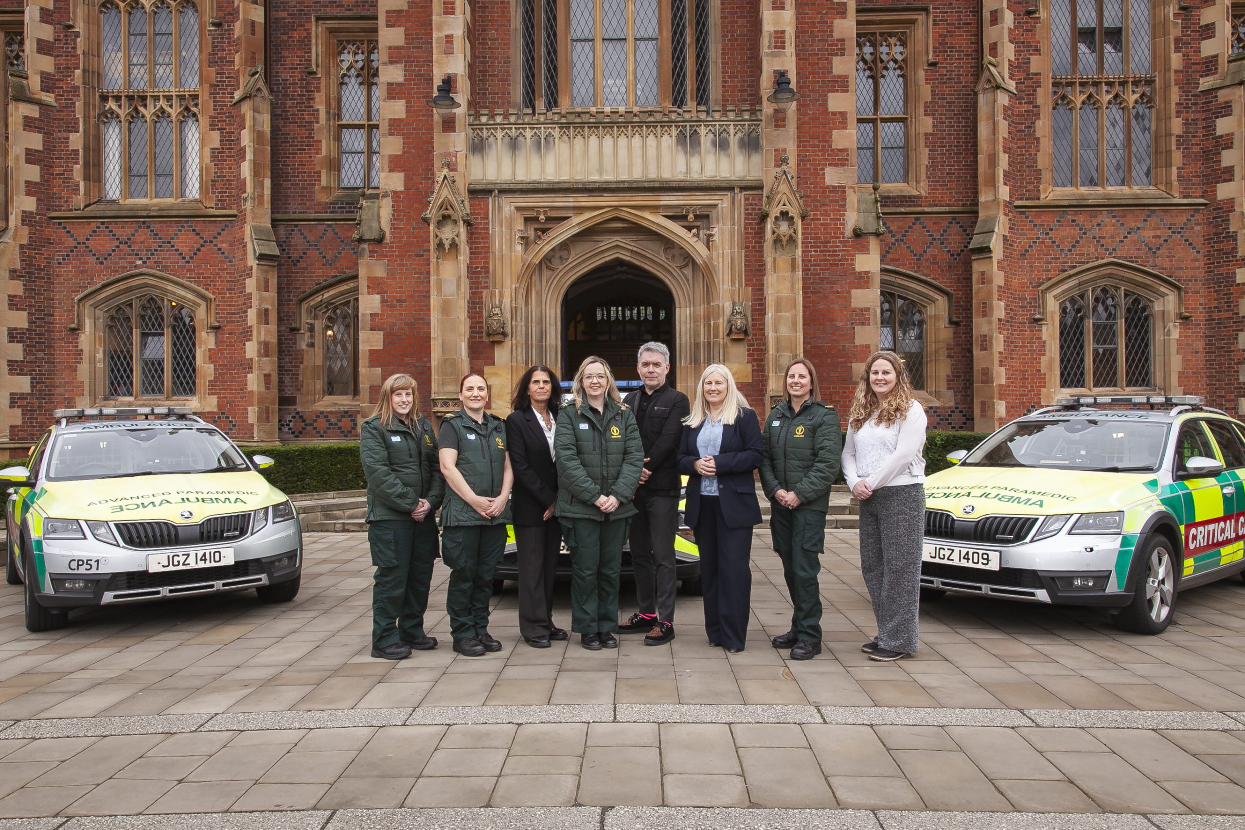 Group photo of staff outside Queens University Belfast Building